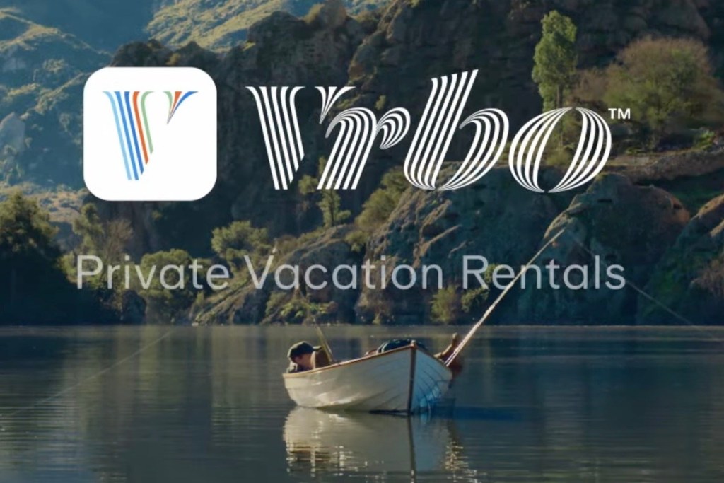 A serene image featuring a man fishing from a small boat on calm water, with lush green hills in the background and the Vrbo logo above the text 'Private Vacation Rentals'.